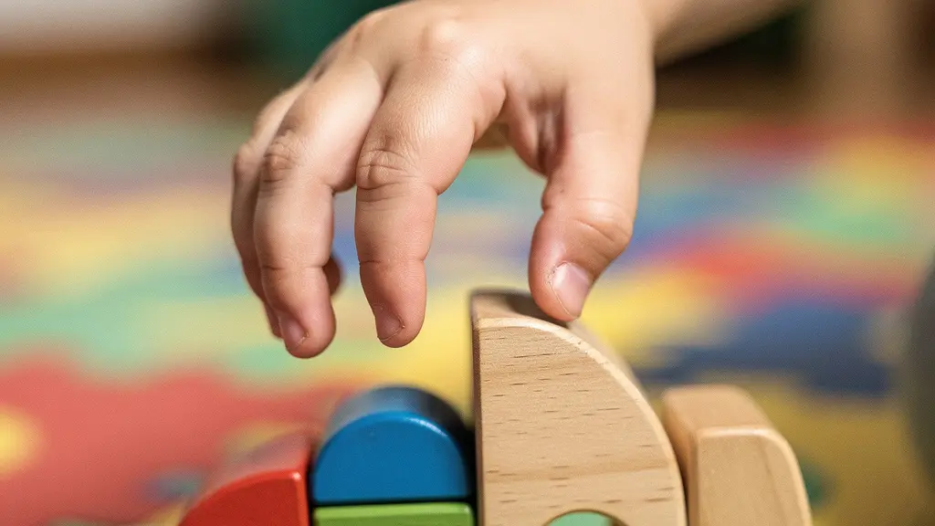 Close-up of a child's hand pausing before reaching for a toy, showing restraint